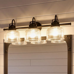 A unique 8-3/4"H x 26-1/4"W lighting fixture from the Harlow Collection featuring four lights and a mirror.