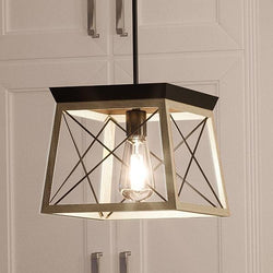 A beautiful Urban Ambiance UHP2125 Industrial Chic Pendant, 9"H x 10"W, Charcoal Finish from the Berkeley Collection is hanging over a kitchen counter.
