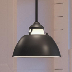 An UHP2151 Americana pendant lighting fixture hanging over a beautiful kitchen island.