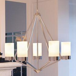 An unique lighting fixture, the UHP2300 Contemporary Chandelier from the Madison Collection by Urban Ambiance hangs over a fireplace in a living room.