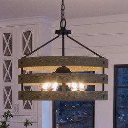 A unique UHP2474 Modern Farmhouse Chandelier from the Adelaide Collection by Urban Ambiance, a luxury lighting fixture hanging over a dining room table.