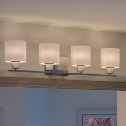 A luxurious lighting fixture, the Urban Ambiance UHP2514 Cosmopolitan Bathroom Vanity Light in Brushed Nickel Finish from the Tacoma Collection features four hanging lights above.