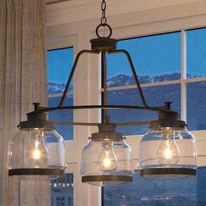 An Urban Ambiance UHP2533 Industrial Chic Chandelier with three glass jars hanging over a window creating a gorgeous urban ambiance.