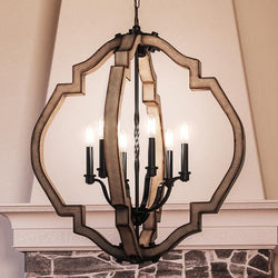 Keyword: luxury
Description: A luxurious UHP3031 Rustic Chandelier from the Wycombe Collection, with an Olde Iron Finish, elegantly hanging over a fireplace in a living room by