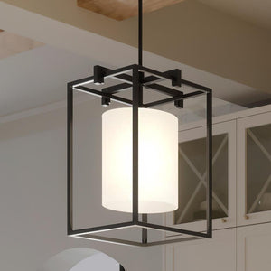 An UHP3111 Minimalist Pendant Light with a glass shade hanging over a kitchen counter, providing gorgeous lighting fixture.