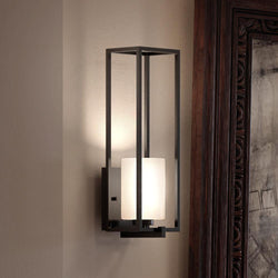 A luxury lighting fixture with a glass shade, the UHP3141 Minimalist Wall Light from the Kennewick Collection by Urban Ambiance features a Midnight Black Finish.