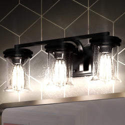 An Urban Ambiance French Country Bath Vanity Light with three beautiful lights and a tiled wall.