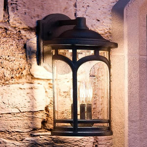 An UQL1102 Rustic Outdoor Wall Light with a beautiful glass shade.