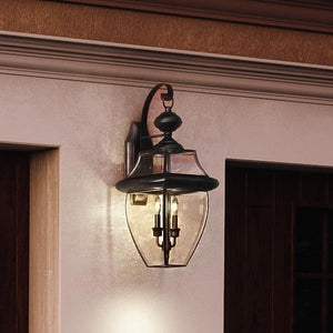 Gorgeous UQL1144 Colonial Outdoor Wall Light, 20"H x 10.5"W, Black Silk Finish from the Cambridge Collection by Urban Ambiance on the side of a house.