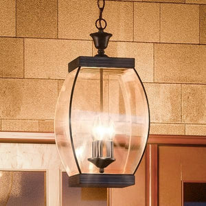 A beautiful UQL1176 Colonial Outdoor Pendant Light is hanging from a brick wall.