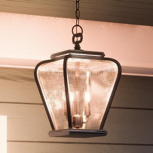 A beautiful French Country Outdoor Pendant Light from the Florence Collection brand Urban Ambiance hanging from the side of a house.