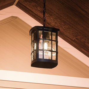A gorgeous UQL1250 Craftsman Outdoor Pendant Light, from the Zurich Collection by Urban Ambiance, hanging from the ceiling of a house.