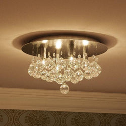 An Urban Ambiance UQL2083 Crystal Flush Mount Ceiling Light, 7.75"H x 13.75"W, Manhattan Collection with crystals hanging from it; a gorgeous lighting fixture.