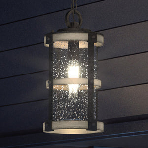 A beautiful UEX1103 Farmhouse Outdoor Pendant 15''H x 8''W lighting fixture, hanging from the side of a house.