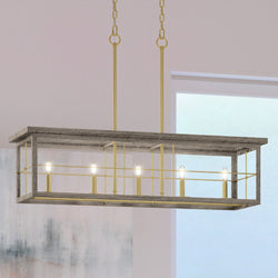 A unique UHP3954 Modern Farmhouse Chandelier, 11''H x 40''W lighting fixture, with a Distressed Brass Finish from the Ballina Collection hanging over a