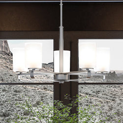 A gorgeous UHP4100 Modern Chandelier lighting fixture by Urban Ambiance in a room with a large window.