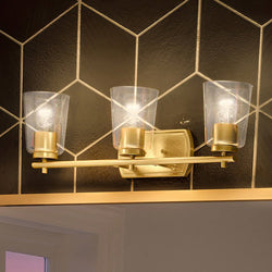 A gorgeous bathroom with a unique Urban Ambiance UHP4147 Traditional Bath Light 7.625''H x 23''W, Satin Gold Finish, Esperance Collection tiled wall.