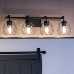 A bathroom with four UHP4187 Industrial Bath Light fixtures and a barn door by Urban Ambiance, creating a luxurious lighting ambiance.