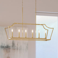 A beautiful UHP4260 Traditional Chandelier from the Coronado Collection by Urban Ambiance, hanging over a dining room table.