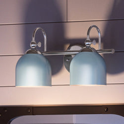 A bathroom with two UHP4311 Vintage Bath Light 9''H x 14.75''W, Polished Chrome Finish fixtures, creating luxurious lighting ambiance.