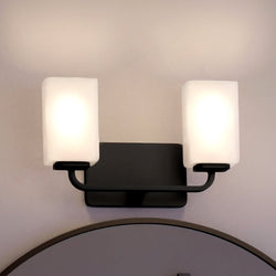 A luxury Urban Ambiance bathroom with two UHP4329 Contemporary Bath Lights 8.5''H x 13.5''W lighting fixtures, Midnight Black Finish, Louisville Collection lights