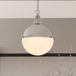 A beautiful lighting fixture, ULB2001 Modern Farmhouse Pendant, hanging over a kitchen counter.