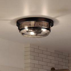 A beautiful bathroom with a unique UQL3781 Coastal Ceiling 5.5''H x 14.75''W lamp and shower.