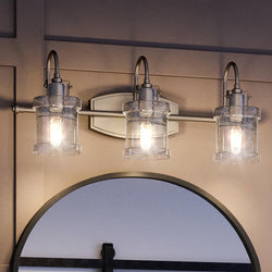 A gorgeous lighting fixture from the Wrexham Collection by Urban Ambiance, this UQL3981 Modern Farmhouse Bath Fixture features three lights and a mirror, exuding luxury.