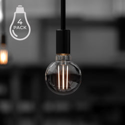 A clear glass UBB2102 Luxury LED bulb by Urban Ambiance hangs from a black fixture, showcasing illuminated filaments. An icon marked "4 Pack" emphasizes its 40W equivalent efficiency in Vintage Edison style with a G16 shape and E12 base (candelabra), offering 3000K soft white light.