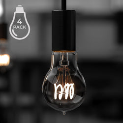 Close-up of an Urban Ambiance UBB2180 Luxury LED bulb in vintage Edison style with visible filament, hanging from a black fixture. The "4 PACK" label highlights its 2200K glow.