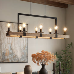A UFS2001 Modern Farmhouse Chandelier (15''H x 44''W, Matte Black & White Ash) from Urban Ambiance's Broadway Collection hangs over a dining table with dried flowers; abstract art and greenery complete the scene.
