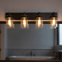 The Urban Ambiance UHP2145 Modern Farmhouse Industrial Bath Fixture from the Bridgeport Collection features four exposed bulbs and glass shades in an olde bronze finish, ideal for vintage-inspired bathroom lighting.