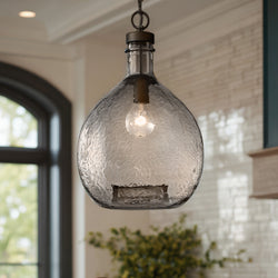 Close-up of the Urban Ambiance UHP2771 Modern Farmhouse Pendant from the Hobart Collection, 20-3/8"H x 13"W, in an Olde Bronze finish, with a visible bulb, hanging in a bright modern room.
