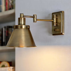 The Urban Ambiance UHP3312 Traditional Wall Light, 9.625"H x 8.25"W in Olde Brass from the Pawtucket Collection features an adjustable swing-arm and conical shade, perfect for adding flexible lighting to your reading nook.