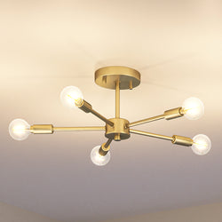 An Urban Ambiance pendant light fixture with four UHP4347 Mid-Century Modern Ceiling Lights 5.625''H x 16''W, Brushed Bronze Finish from the Albuquerque Collection in a room.