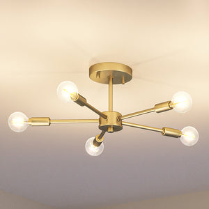 An Urban Ambiance pendant light fixture with four UHP4347 Mid-Century Modern Ceiling Lights 5.625''H x 16''W, Brushed Bronze Finish from the Albuquerque Collection in a room.
