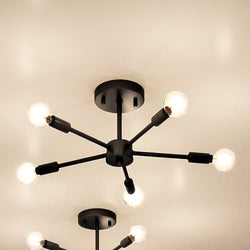 A UHP4348 Mid-Century Modern Ceiling Light 5.625''H x 16''W, Midnight Black Finish, Albuquerque Collection by Urban Ambiance with four lights on it.