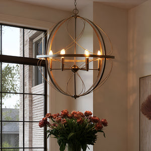 The Urban Ambiance UHP4402 Omaha Collection Farmhouse Chandelier (31.875''H x 28''W, Olde Bronze Finish) hangs above a vase of pink flowers, bringing farmhouse charm and stylish lighting to a room with large windows.