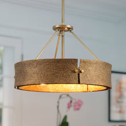The Urban Ambiance UHP5034 Modern Rustic Indoor Pendant from the Richmond Collection, featuring a soft gold finish, hangs elegantly from the ceiling, enhancing the contemporary interior space.