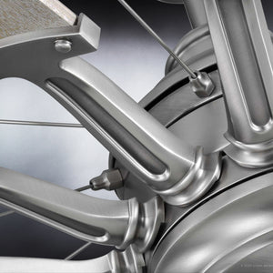 A close-up view of the UHP9021 Traditional Indoor Ceiling Fan from the Saybrook Collection by Urban Ambiance reveals its intricate metallic structure, featuring spokes, joints, and polished metal surfaces in an aged nickel finish.