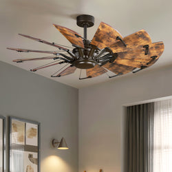 The UHP9471 Tuscan Indoor Ceiling Fan by Urban Ambiance, with large blades and an architectural bronze finish, elevates this modern room with grey walls, framed artwork, and curtained windows.
