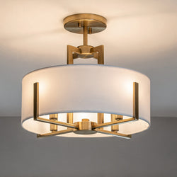 The Urban Ambiance UKC20372 Transitional Ceiling Light from the Oakmont Collection features a contemporary Champagne Bronze finish, complemented by a round white fabric drum shade. Measuring 14.25''H x 15.5''W x 15.5''Dep, this beautifully illuminated pendant is mounted on a white ceiling for a modern look.