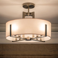The Urban Ambiance UKC20374 Transitional Ceiling Light from the Oakmont Collection features a classic pewter finish and a round fabric shade, measuring 14.5'' high by 20'' wide and deep, mounted to a white ceiling with beige trim for a modern touch.