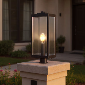 The Urban Ambiance UQL1333 Quincy Collection Farmhouse Outdoor Post Light, 20.5"H x 7"W in Black, is mounted on a stone pillar in front of the house.