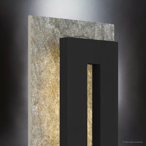 The Urban Ambiance UQL1880 Luxe Industrial Outdoor Wall Sconce from the Burnie Collection features an earth black finish, marine-grade construction, and integrated LED for soft, indirect lighting with modern appeal. Measures 18.25