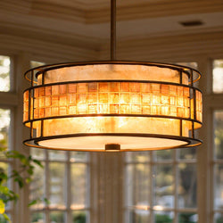 The UQL2431 Art Deco Chandelier by Urban Ambiance, featuring a copper revival finish and white/amber glass shade, hangs in a room with large windows.