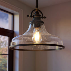 The Urban Ambiance UQL3664 Pasadena pendant features a clear speckled glass shade and vintage-style bulb, highlighted by elegant Parisian Bronze finish accents. Measures 10.75"H x 13.5"W.
