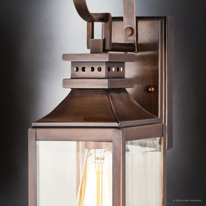 Close-up of the Urban Ambiance UFS1000 Calderdale Collection outdoor wall sconce in genuine copper with a dark-patina finish and clear glass panels, showing the bulb inside. Size: 15''H x 5.5''W.