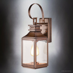 The Urban Ambiance UFS1000 Calderdale Collection features a 15''H x 5.5''W transitional outdoor wall sconce in genuine copper with dark-patina finish, mounted on a rectangular backplate, showcasing sleek style and durability.