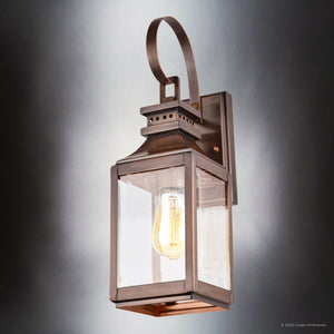 The Urban Ambiance UFS1000 Transitional Outdoor Wall Sconce from the Calderdale Collection features genuine copper with a dark-patina finish, a clear glass enclosure, exposed bulb, and measures 15''H x 5.5''W.